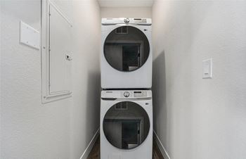 A white dryer and washer in a small laundry room.